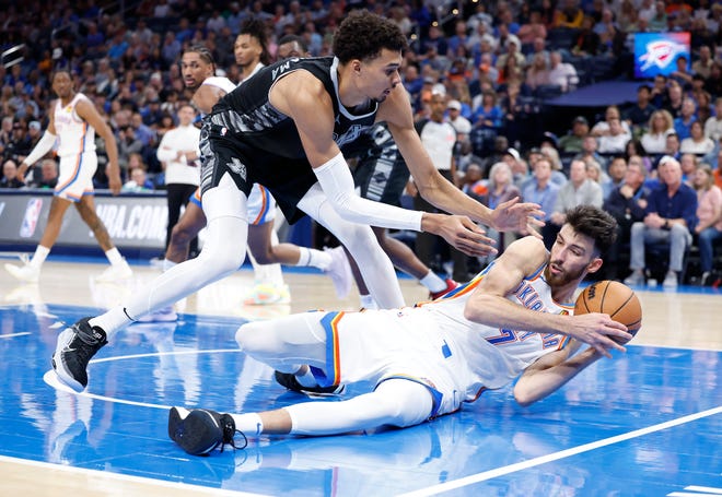 Oct 30, 2024; Oklahoma City, Oklahoma, USA; San Antonio Spurs center Victor Wembanyama (1) works to steal the ball from Oklahoma City Thunder forward Chet Holmgren (7) after he fell to the floor during the second half at Paycom Center. Mandatory Credit: Alonzo Adams-Imagn Images