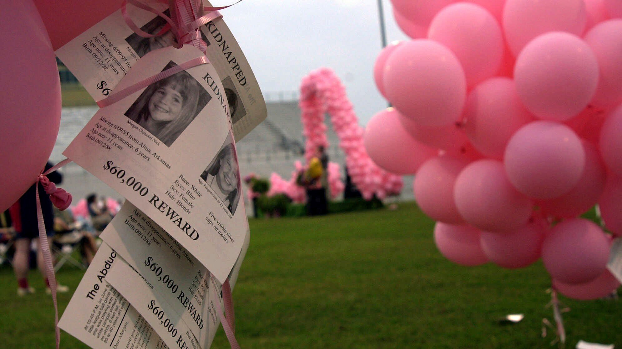 Notices of the kidnapping of Morgan Nick hang from balloons during the One Hope 2000 ceremony in Alma, Ark., June 3, 2000.