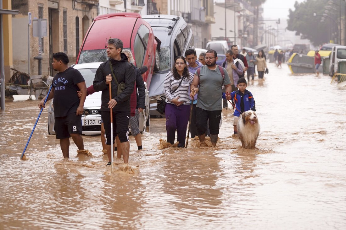 People walk through flooded streets in Valencia, Spain on Wednesday.