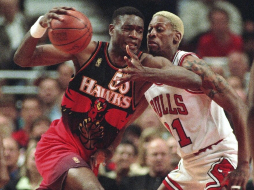 Dikembe Mutombo, playing at the time for the Atlanta Hawks, drives to the hoop against the Chicago Bulls' Dennis Rodman during the second quarter of a playoff game May 8, 1997, in Chicago.