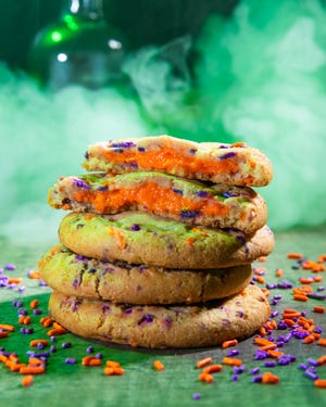 McAlister’s Trick-or-Treat Cookie, a sweet, buttery cookie with a cream cheese filling and orange and purple sprinkles.