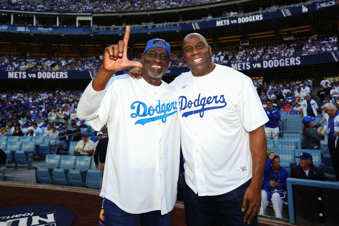 Michael Cooper and Magic Johnson on the field prior to Game 6 between the Mets and Dodgers on Sunday at Dodger Stadium. (Photo by Daniel Shirey/MLB Photos via Getty Images)