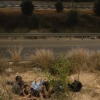 In this photo, several Israelis lie face down on the ground beside a highway, taking shelter during a massive missile barrage from Iran on October 1, 2024.