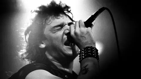 Getty Images A black and white photograph of Paul Di'Anno performing with Iron Maiden in 1981.