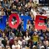 Supporters hold signs as former President Barack Obama speaks during a campaign event for Vice President Harris in Pittsburgh on Oct. 10.