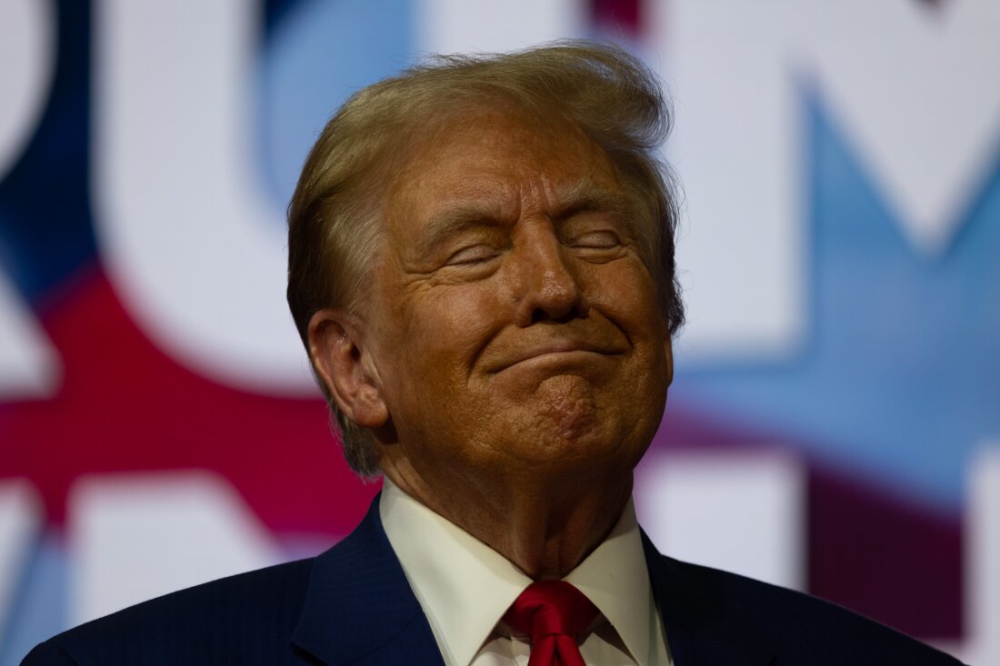 In this photo, former President Donald Trump, the Republican presidential nominee, holds a town hall in Oaks, Pa., on Oct. 14. He's wearing a suit, is smiling and has his eyes closed.