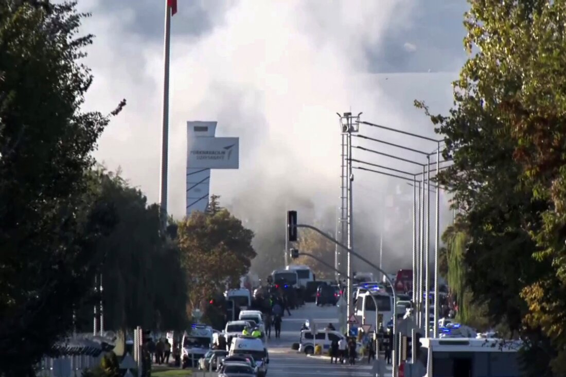 Smoke rises as emergency rescue teams and police officers attend to the scene of an attack outside Turkish Aerospace Industries Inc. on the outskirts of Ankara, Turkey, Wednesday.