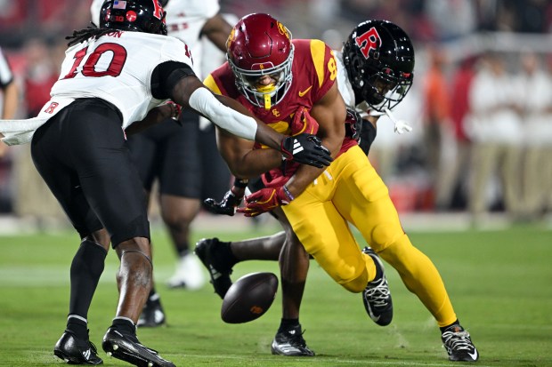 USC wide receiver Kyle Ford loses the ball as Rutgers’...