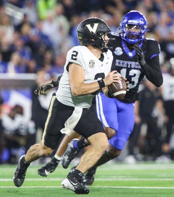 Llinebacker J.J. Weaver (13) of the Kentucky Wildcats tries to pressure quarterback Diego Pavia (2) of the Vanderbilt Commodores in the first half Saturday, Oct. 12, 2024 in Lexington, Ky.