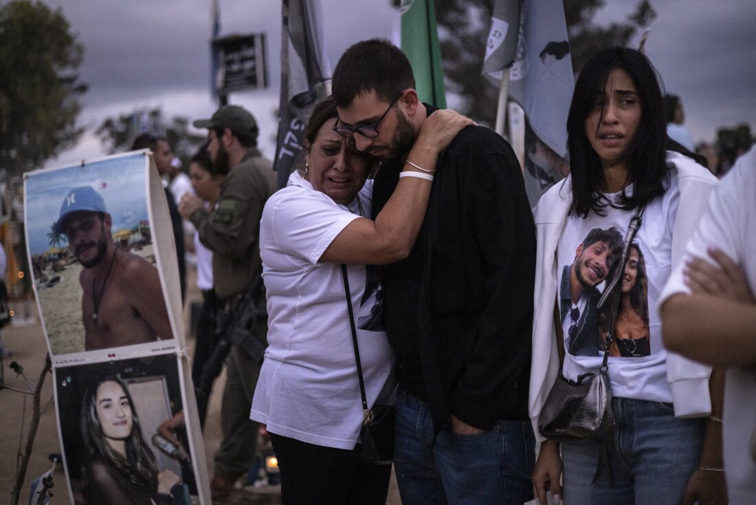 Two people embrace as relatives and supporters of Israelis killed in the Oct. 7, 2023 Hamas attack attend a ceremony at the Nova memorial near Kibbutz Reim in southern Israel on Oct. 7, 2024.