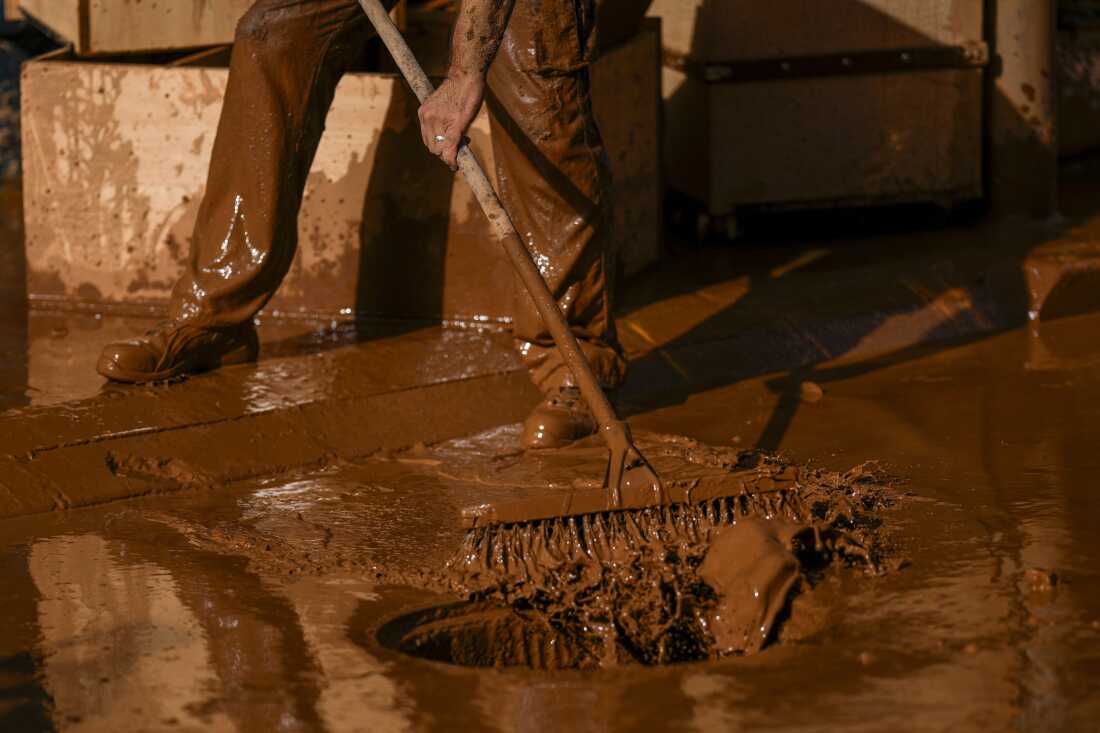 A person removes mud after the floods in Utiel, Spain on Wednesday.