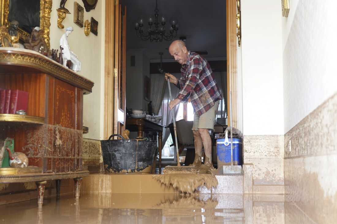 A man cleans his house affected by floods in Valencia, Spain on Wednesday.