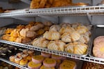 Different types of pan de muerto for sale at Colima Market in Bend, Ore., Oct. 29, 2024. The frosted version is also known as "la catrina."