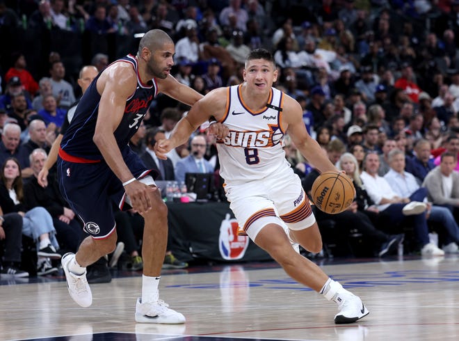 Grayson Allen #8 of the Phoenix Suns drives to the basket past Nicolas Batum #33 of the LA Clippers during a 116-113 Phoenix Suns overtime win in the season home opening game at Intuit Dome on Oct. 23, 2024, in Inglewood, California.