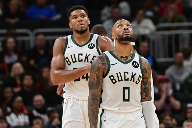 Milwaukee Bucks forward Giannis Antetokounmpo (34) and guard Damian Lillard (0) look on in the second quarter against the Chicago Bulls at Fiserv Forum in Milwaukee on Oct. 14, 2024.