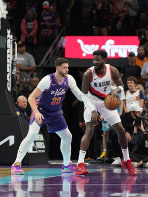 Portland Trail Blazers center Deandre Ayton (2) dribbles against Phoenix Suns center Jusuf Nurkic (20) during the first half at Footprint Center in Phoenix on Nov. 21, 2023.