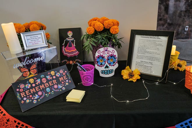 A remembrance ofrenda is set up for people to write a message to a loved one who has died at a Dia de los Muertos display in Lansing City Hall Friday, Nov. 1, 2024.