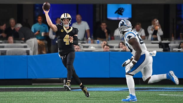 New Orleans Saints quarterback Derek Carr (4) passes on the move against the Carolina Panthers 