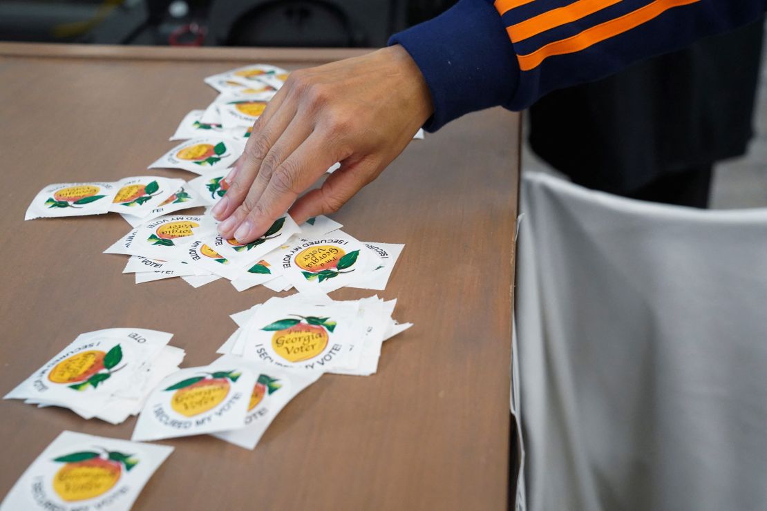 A person picks up a sticker at a polling station in Atlanta on October 16, 2024.