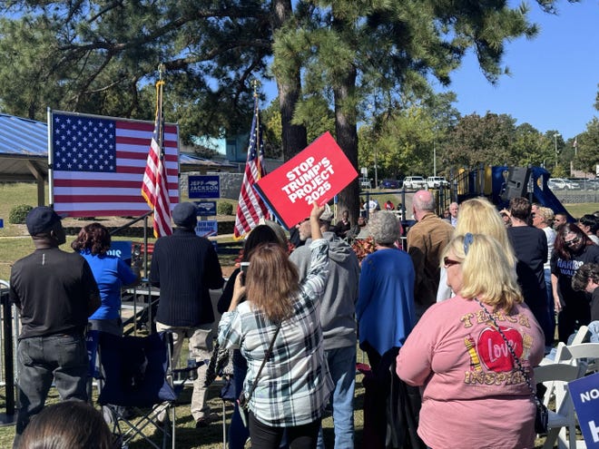 A woman holds an anti-Project 2025 sign at the Early Vote Block Party with Bill Clinton at Seabrook Park, Saturday, Oct. 19, 2024.