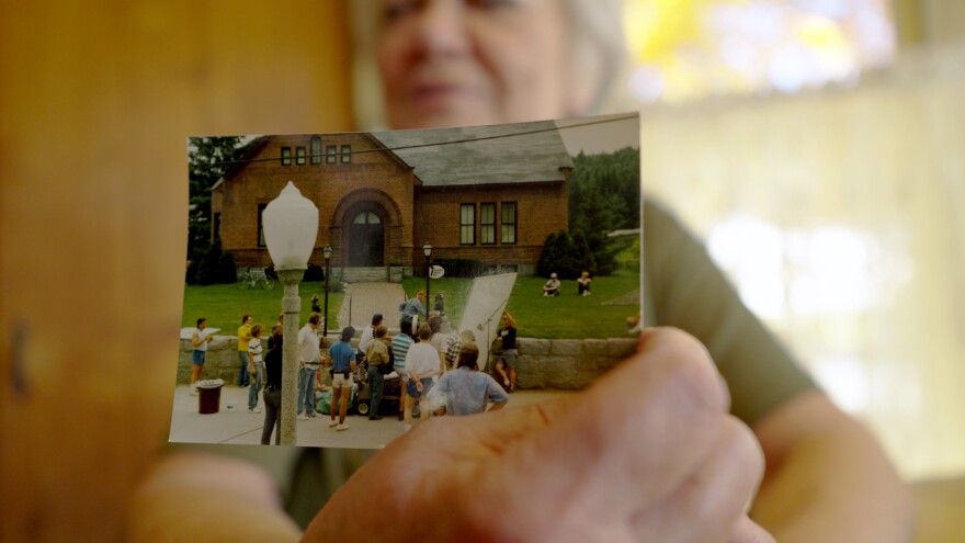 Woman shows a photo of the Beetlejuice movie set in 1980s. 