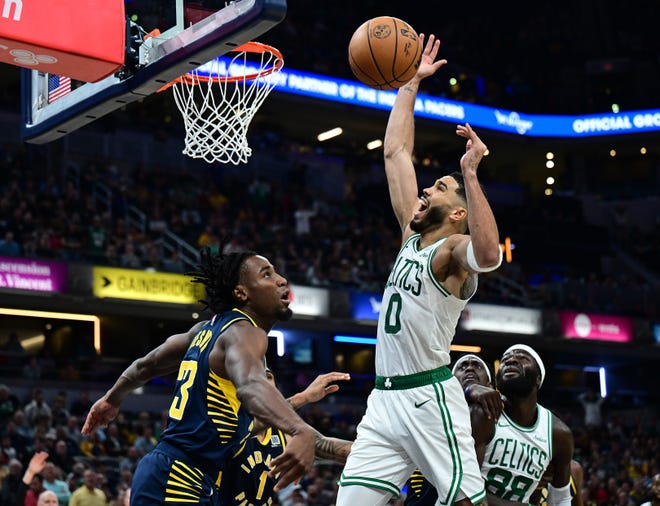 Oct 30, 2024; Indianapolis, Indiana, USA; Boston Celtics forward Jayson Tatum (0) loses control of the ball in front of Indiana Pacers forward Aaron Nesmith (23) during the second half at Gainbridge Fieldhouse. Mandatory Credit: Marc Lebryk-Imagn Images