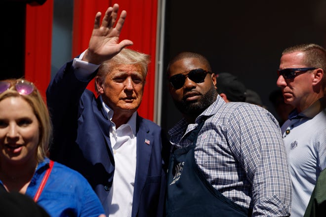 Former President Donald Trump visits the Iowa Pork Producers Tent with Rep. Byron Donalds, R-Fla., at the Iowa State Fair on Aug. 12, 2023 in Des Moines, Iowa. Republican and Democratic presidential hopefuls are visiting the fair, a tradition in one of the first states that will test candidates with the 2024 caucuses.