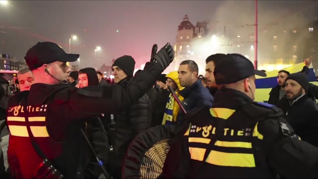 In an image taken from video, police are seen escorting Maccabi Tel Aviv soccer team supporters to the metro station, leading them to the Ajax stadium, after pro-Palestinian supporters marched near the stadium, in Amsterdam, Thursday.