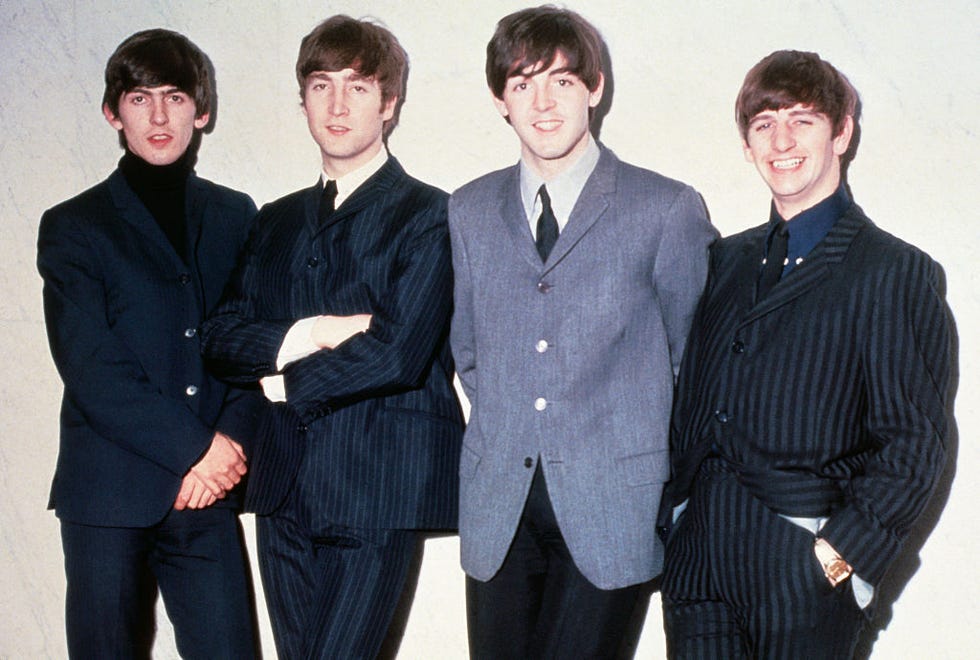 the beatles posing together for a photo and smiling