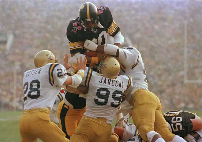 Iowa fullback David Hudson goes over the top of a group of UCLA defenders to score the first touchdown in the Rose Bowl in Pasadena, Calif., Jan. 1, 1986. (AP Photo)