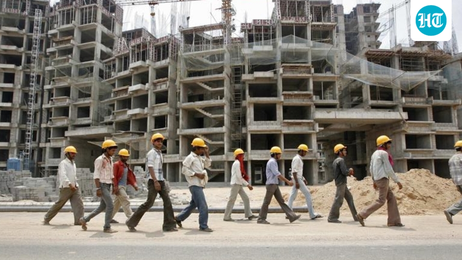 commercial-ahmedabad-complex-workers-walking-construction-outskirts_a5e3e9ec-f751-11e6-aa44-d0b605bc.webp